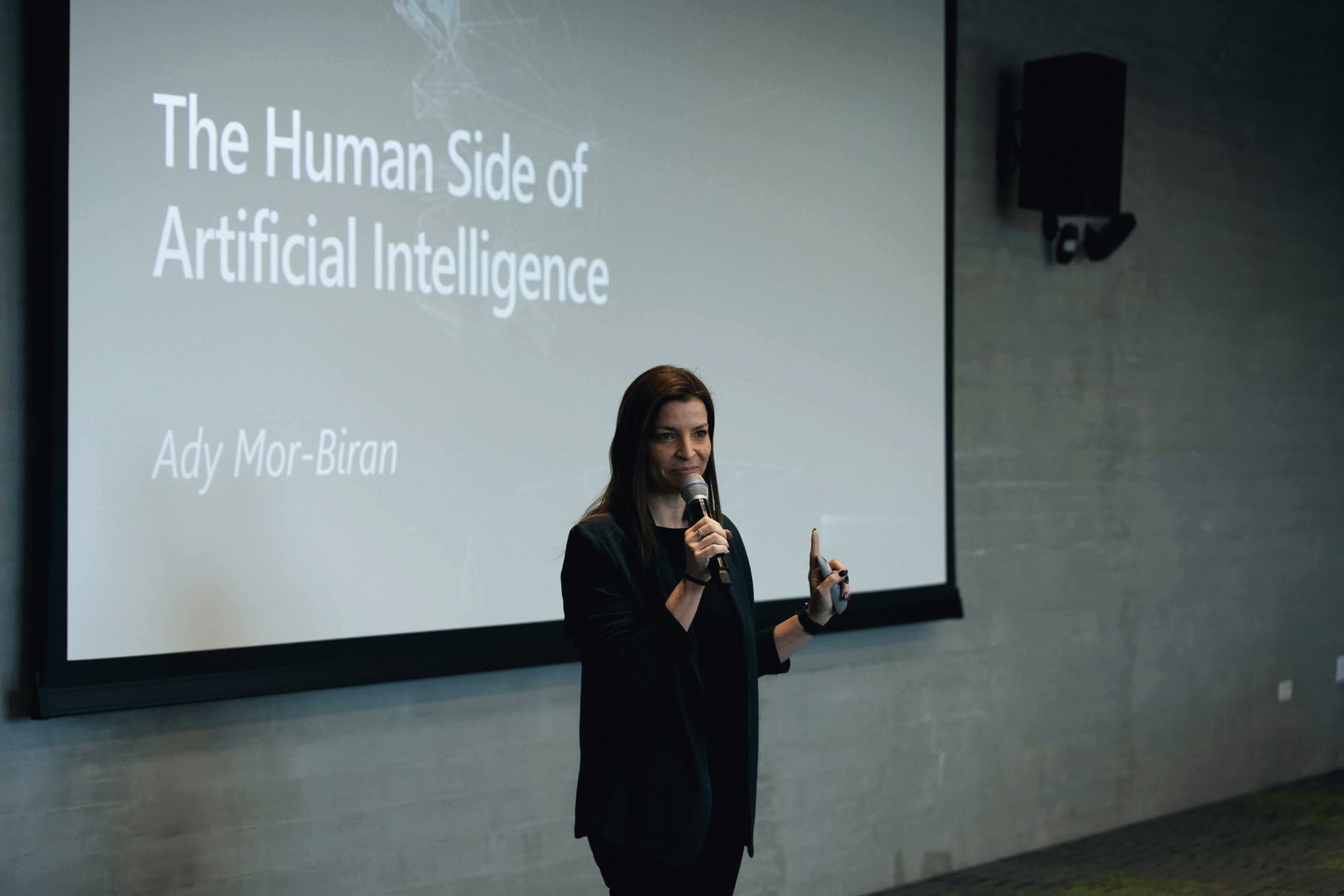 Ady Mor-Biran speaking in front of her title slide, "The Human Side of Artificial Intelligence".